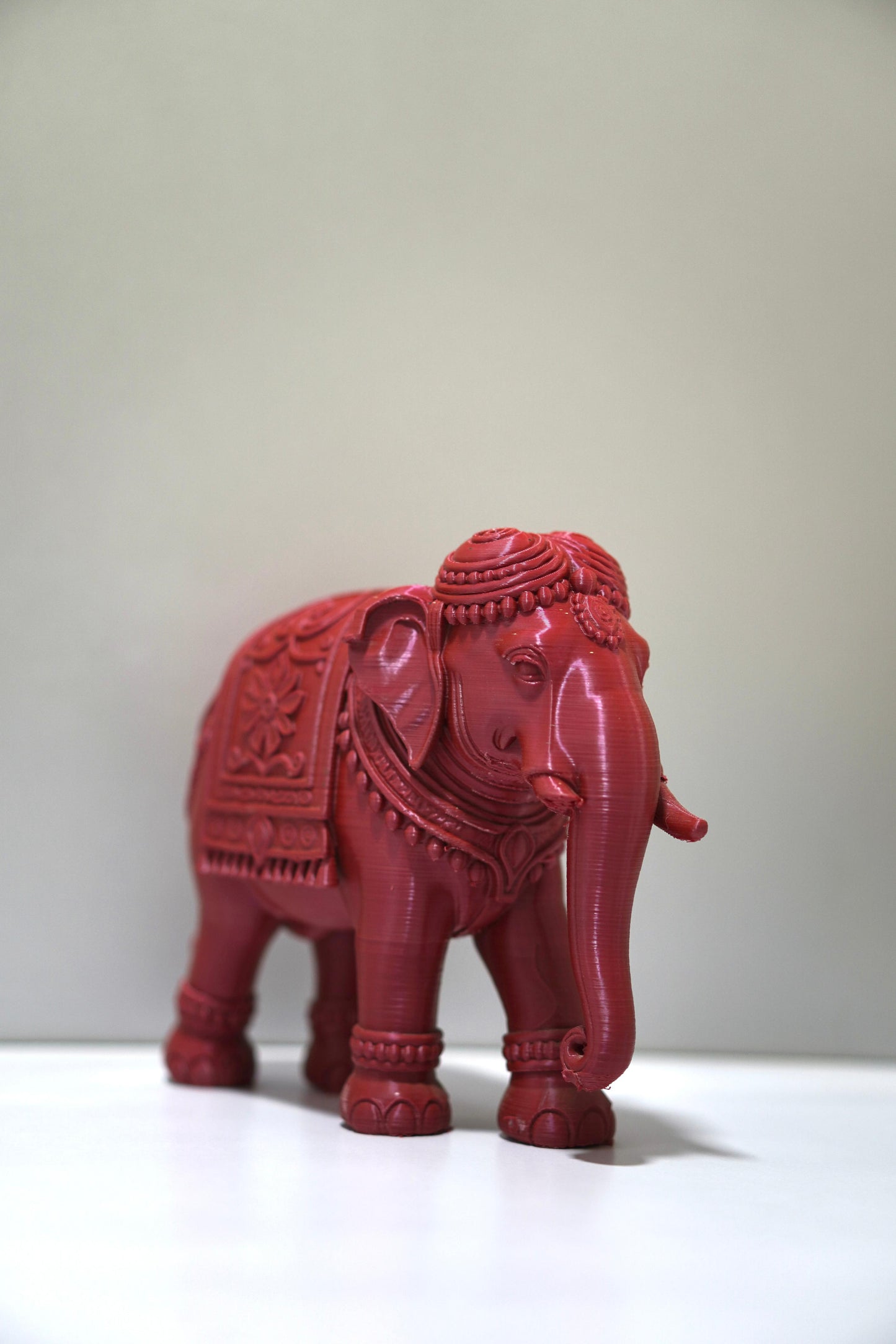 The 6-inch Royal Prosperity Elephant figurine, detailed in red with ornate patterns, stands on a white surface against a plain light background, embodying the Vastu symbol of prosperity.