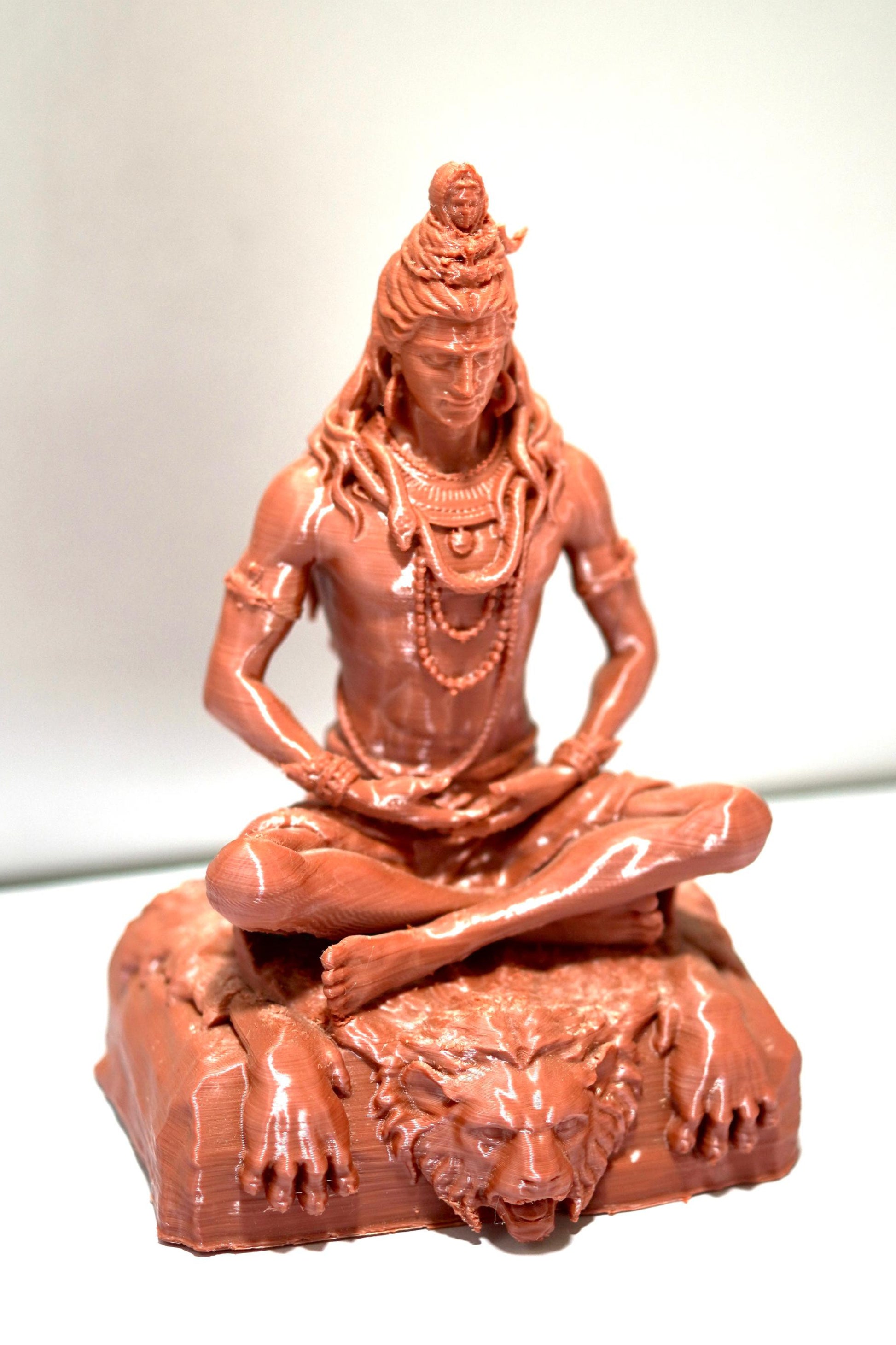The Lord Shiva Meditation Statue - 6.5 Inch Spiritual Energy Symbol features Shiva seated cross-legged with flowing hair and jewelry on a lion-faced base, making it an ideal decor piece for your home temple.